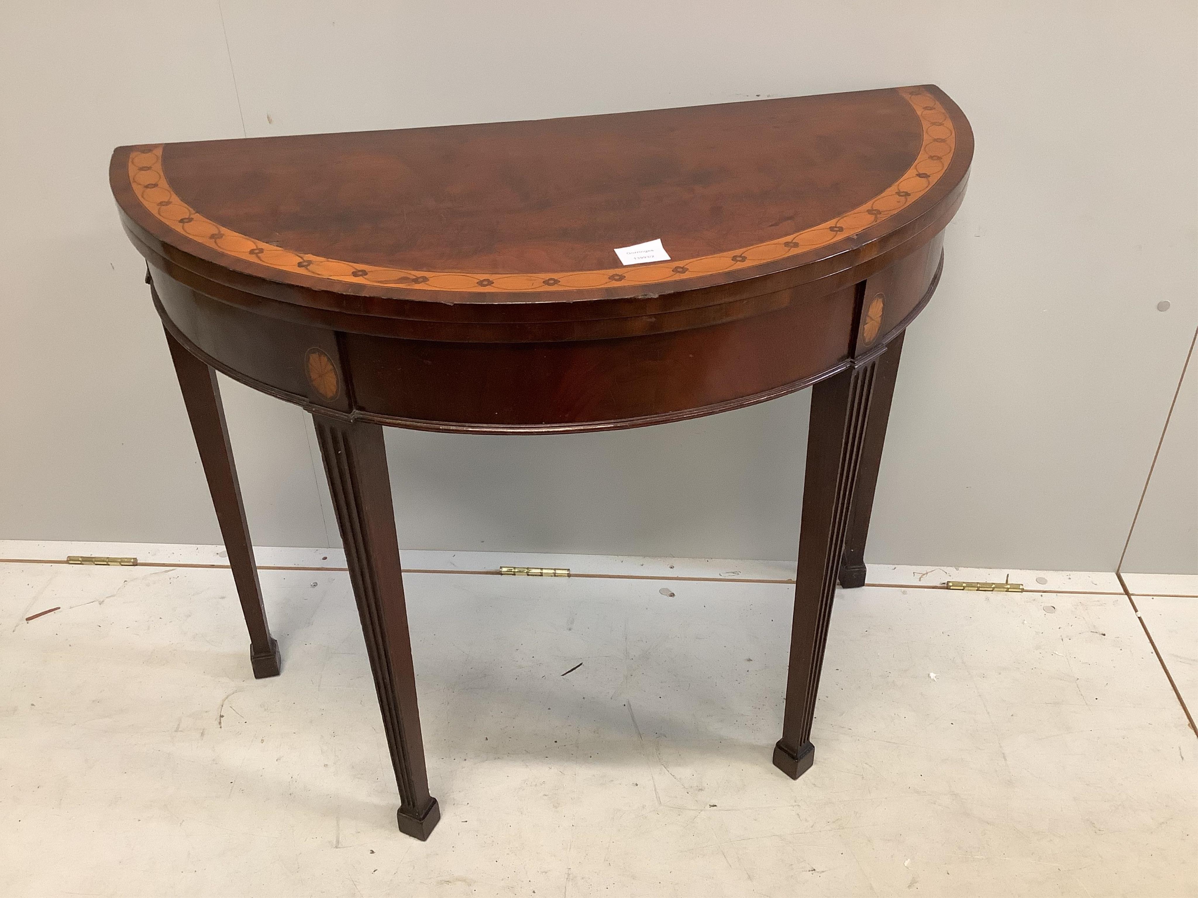 An Edwardian inlaid mahogany demi lune card table, width 91cm, height 73cm. Condition - top scratched, otherwise fair